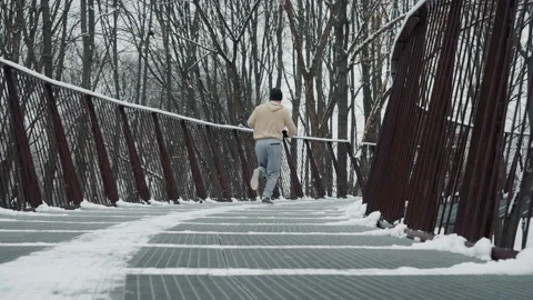Slow motion jogger running on bridge in winter Stock Footage 148106641
