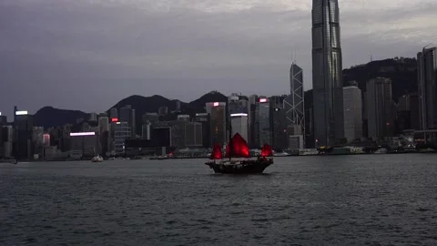 Slow motion of Junk boat sailing across the Victoria Harbour in Hong Kong Stock Footage 166184136