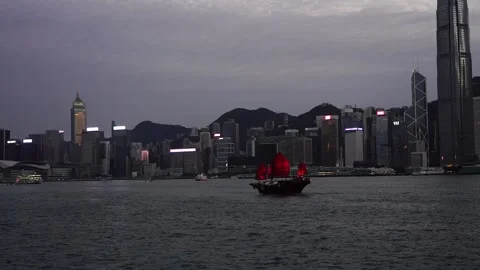 Slow motion of Junk boat sailing across the Victoria Harbour in Hong Kong Stock Footage 166184138