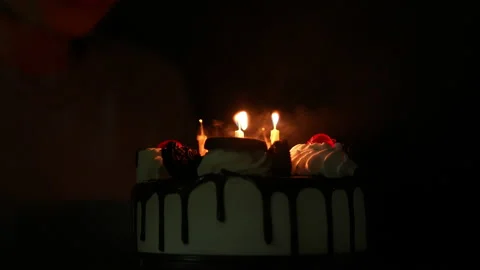 Slow motion kid blowing fire candle on cake of happy birth day cake on night Видео 236839034