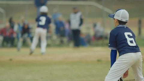 Slow motion of kid catching ball on the field during a baseball game Stock Footage 117080368