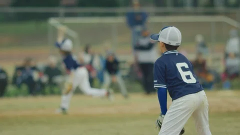 Slow motion of a kid on the field during a baseball game Stock Footage 117076029
