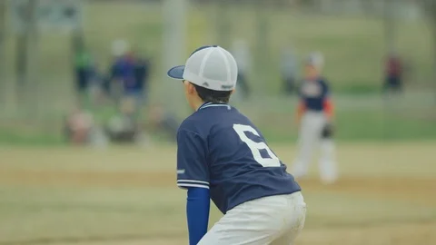 Slow motion of kid in position in middle of baseball game Stock Footage 115925171