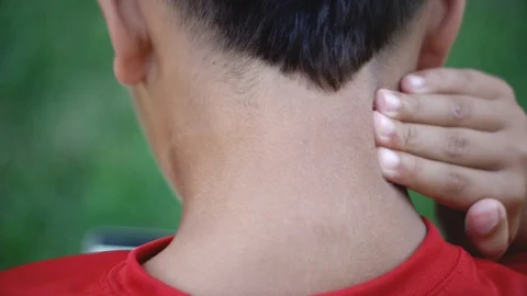 Slow motion of kid rubbing his neck from pain Stock Footage 111049651