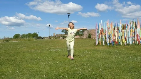 Slow motion. Kid running on the green field. Little girl walking. 스톡 동영상 80909417