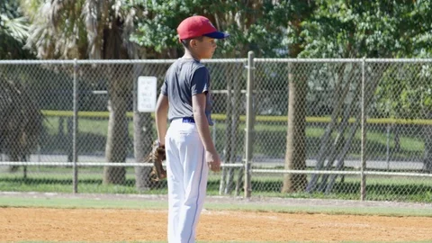 Slow motion of kid with uniform and glove at baseball practice Stock Footage 93716288