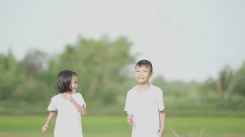 Slow motion kids playing and running on nature of countryside Stock Footage 132920048
