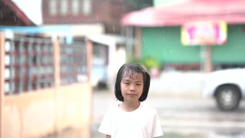 Slow motion Kids playing and joyful on rainning outdoor of home Stock Footage 134912446