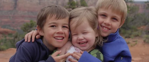 Slow Motion Kids Sitting Close and Smiling Together in a Scenic Spot Stock Footage 61835202