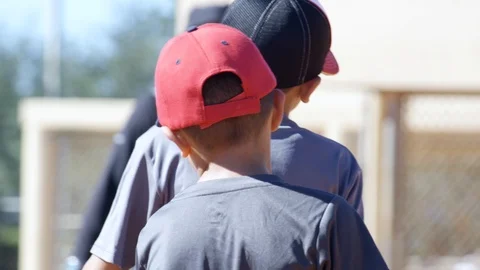 Slow motion of kids standing around during baseball practice Stock Footage 93716072