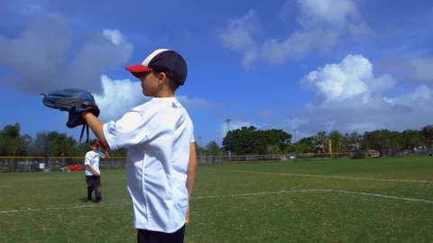 Slow motion of kids throwing and catching at baseball practice Stock Footage 85648894