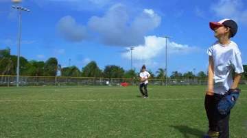 Slow motion of kids throwing and catching balls during baseball practice Stock Footage 85650336