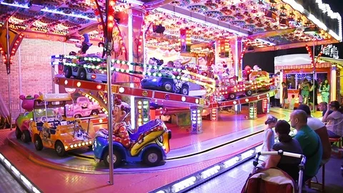 Slow-motion Kids on train amusement  park cars, cartoon characters Stock Footage 69984600