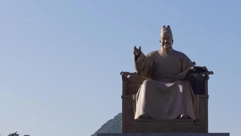 Slow motion of King Sejong statue from behind with clear blue sky Stock Footage 314519079