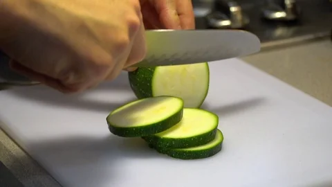 Slow motion kitchen tabletop slice zucchini Stock Footage 76191548