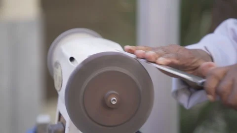 Slow motion of knife sharpner with old hands  Stock Footage 100444893