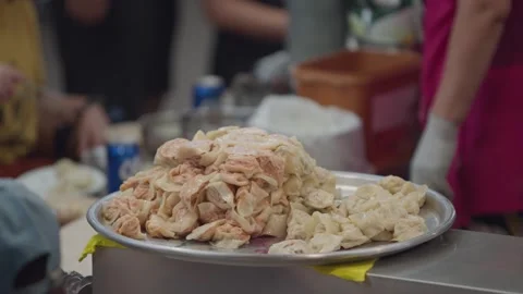 Slow motion of Korean vendors preparing dumplings at Gwangjang Market Stock Footage 313674756