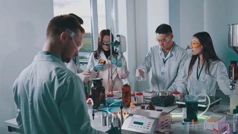 Slow motion in laboratory team of scientists stand work holds a test tube with Stock Footage 148247688