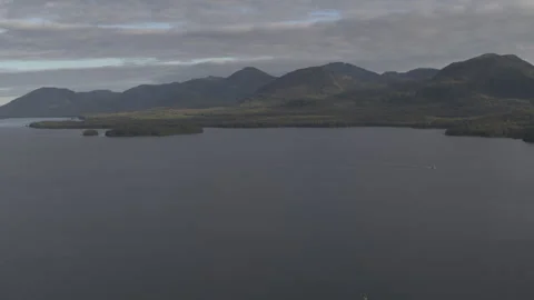 Slow Motion Lake with Pine Tree Mountains in Background Drone Stock Footage 255319162