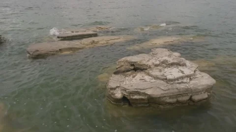Slow motion of lake water waves hitting coral Stock-Footage 307414398