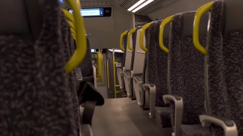 Slow motion landscape of empty train seating with modern upholstery and handles Vidéo 320589892
