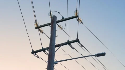Slow motion landscape of an overhead utility electricity pole equipped with Stock Footage 346409063