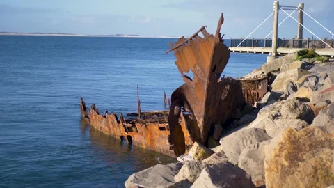 Slow motion landscape of the rusting shipwreck bow and hull remnants landmark Vídeos de archivo 345888395