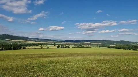 Slow motion landscape view of peaceful fields, meadows, and forests Stock Footage 312867266
