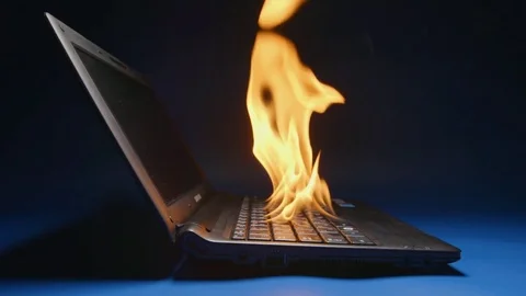 SLOW MOTION: Laptop flaming on a table - Side view Vídeo Stock 74458366