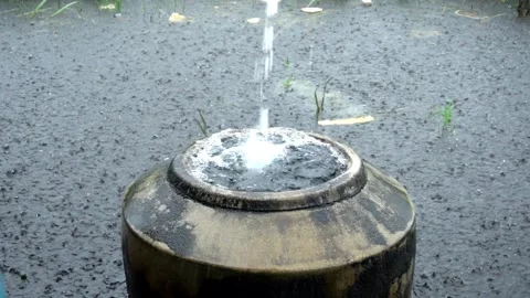 Slow motion of large barrels made of cement filled with rainwater and sit i.. Stock-Footage 304495204