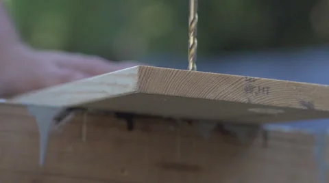Slow Motion Large drill bit drills through wood board Video stock 68347556