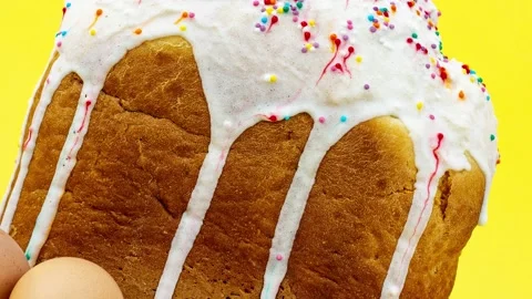 Slow motion large Easter cupcake with white frosting and multicolored confetti Stock Footage 149043244