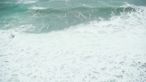 Slow motion a large foamy wave in the sea Stock Footage 87504289