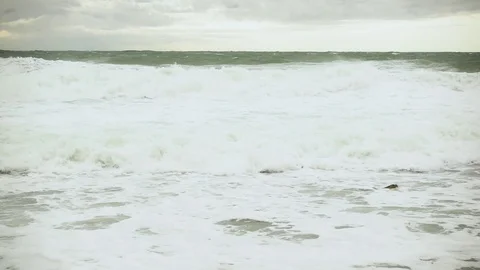 Slow motion large foamy waves in the gray sea Stock-Footage 82120421