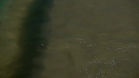 Slow motion of a large sea wave with foam and spray rushes to the shore Stock Footage 92378424