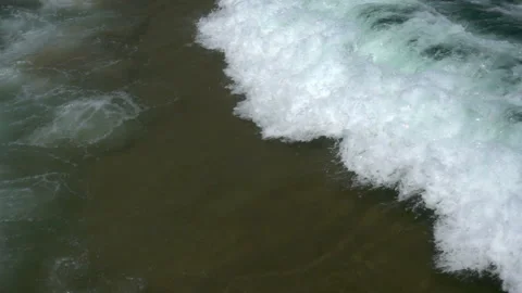 Slow motion of a large sea wave with foam and spray rushes to the shore Stock Footage 92380878