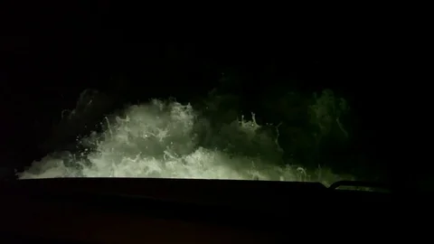 Slow motion of a large wake behind a boat at night Stock Footage 82630754