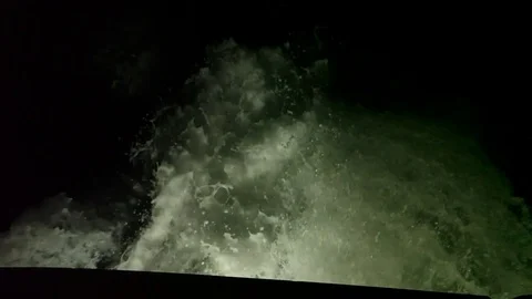 Slow motion of a large wake behind boat at night Stock Footage 82630761