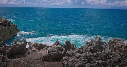 Slow motion of large waves crashing against the rocks of the coastline. Stock Footage 256448861