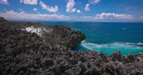 Slow motion of large waves crashing against the rocks of the coastline. Stock Footage 256448920