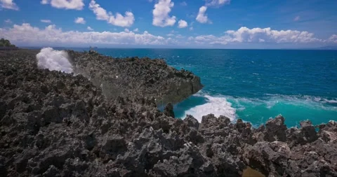 Slow motion of large waves crashing against the rocks of the coastline. Stock Footage 256448996