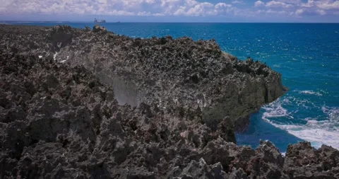Slow motion of large waves crashing against the rocks of the coastline. Stock Footage 256449089