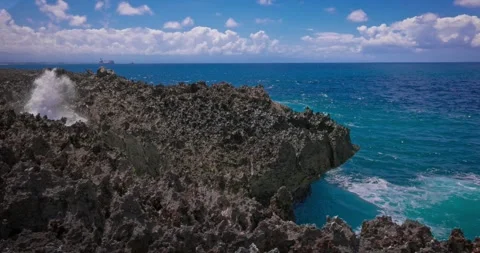 Slow motion of large waves crashing against the rocks of the coastline. Stock Footage 256449174