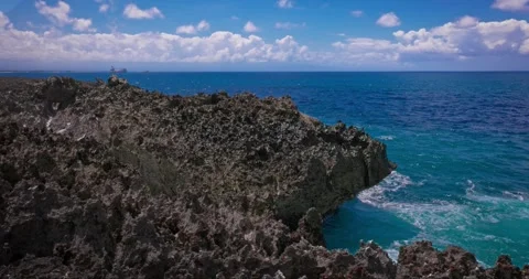 Slow motion of large waves crashing against the rocks of the coastline. Stock Footage 256449213