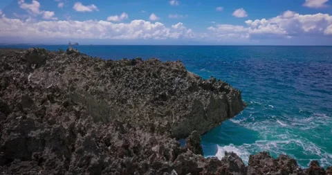 Slow motion of large waves crashing against the rocks of the coastline. Stock Footage 256449247