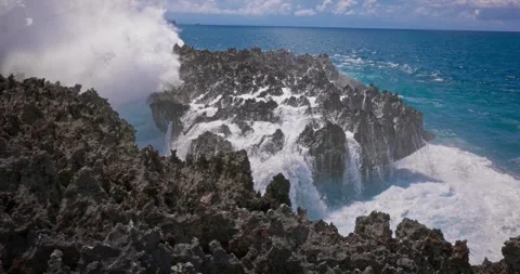 Slow motion of large waves crashing against the rocks of the coastline. Stock Footage 256449307