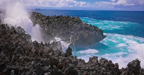 Slow motion of large waves crashing against the rocks of the coastline. Stock Footage 256449389
