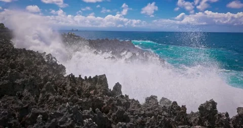Slow motion of large waves crashing against the rocks of the coastline. Stock Footage 256449401