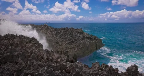 Slow motion of large waves crashing against the rocks of the coastline. Stock Footage 256449485