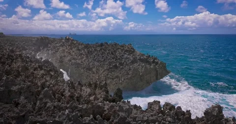 Slow motion of large waves crashing against the rocks of the coastline. Stock Footage 256449543